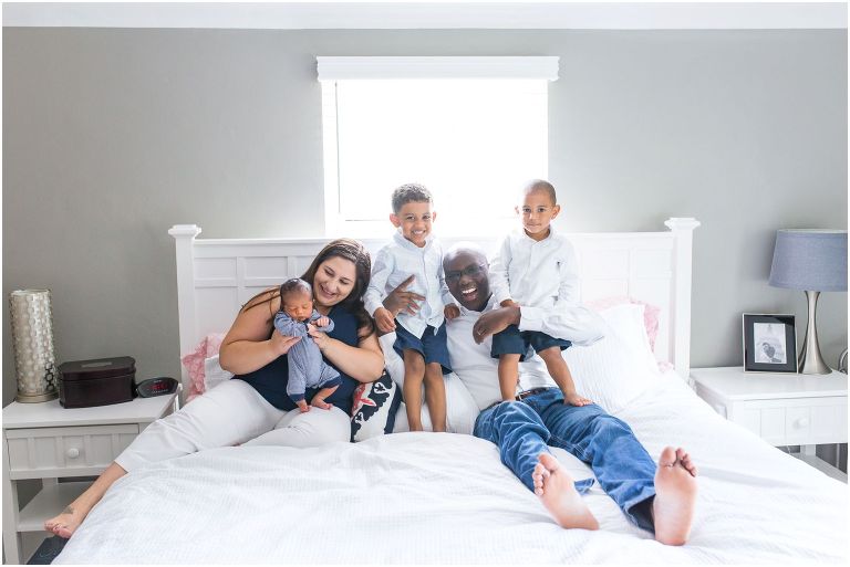 Family on bed at Pittsburgh newborn photo session