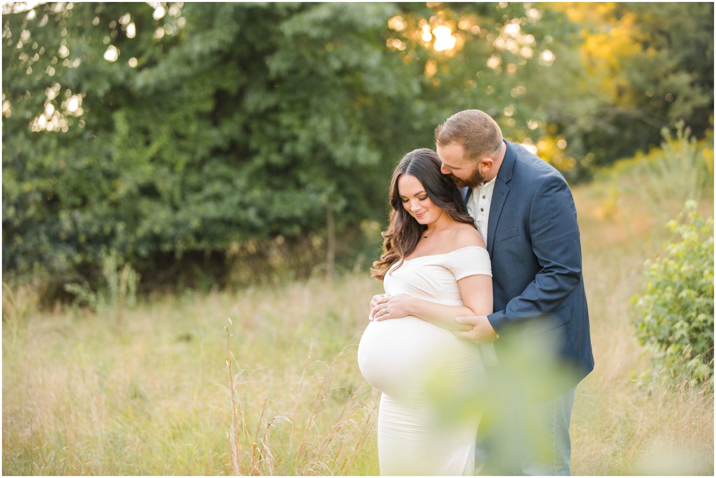 Couple in grassy field for maternity photos at North Park in Pittsburgh