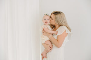 mom in ivory dress and baby in romper, sitter session